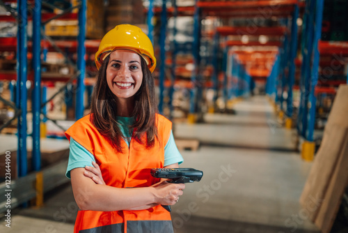 Smiling warehouse worker holding barcode scanner in distribution center photo