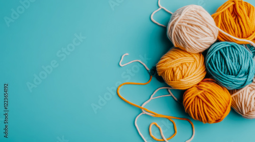 Pastel Yarn Balls on Aqua Background: Crafting Supplies and Hobby photo