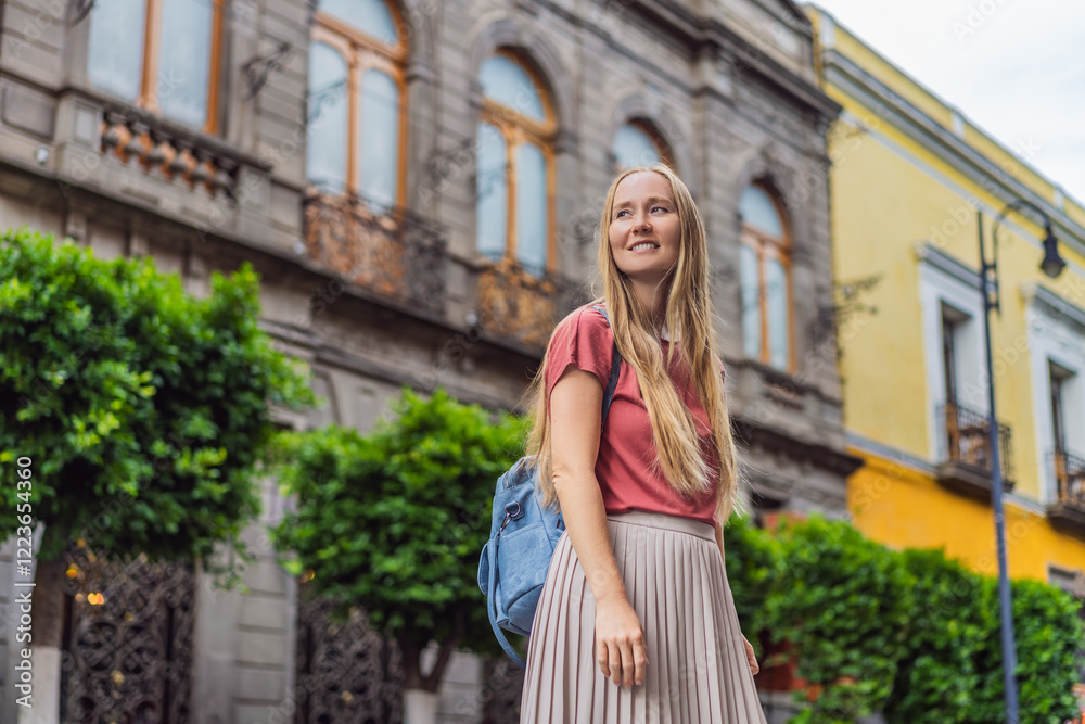 Female tourist walking through the colorful colonial streets of Puebla, Mexico. Travel, cultural exploration, and vibrant architecture concept