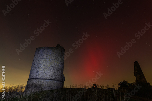 Hadleigh Castle Illuminated by Northern Lights
A striking night view of Hadleigh Castle, framed against the vivid red and green hues of the northern lights. The ancient ruins and glowing sky create a  photo