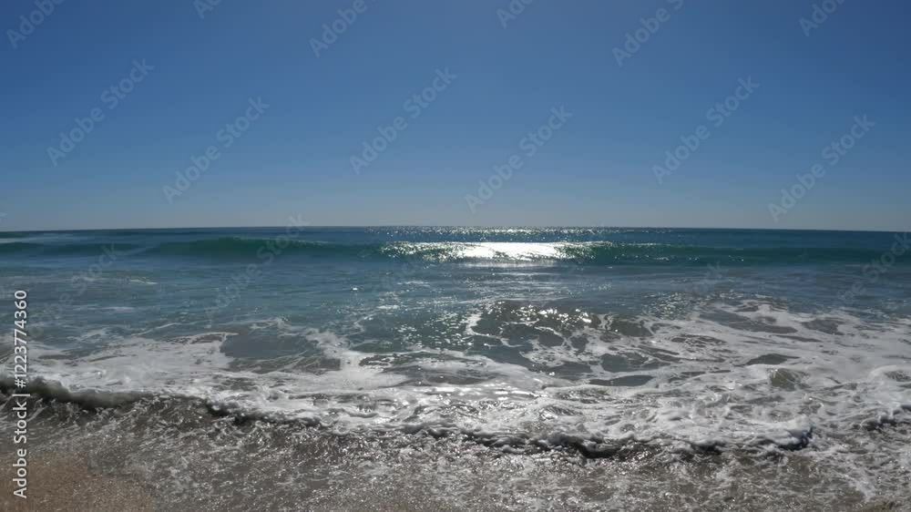 Big foamy wave crashing into the camera at the beach Big foamy wave crashing into the camera at the beach