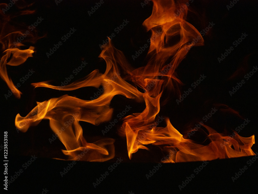 Close-up of dynamic flames on a black background, showcasing vibrant orange and yellow hues. Abstract patterns created by the movement of fire, symbolizing energy, heat, and the raw power of nature. Close-up of dynamic flames on a black background, showcasing vibrant orange and yellow hues. Abstract patterns created by the movement of fire, symbolizing energy, heat, and the raw power of nature.
