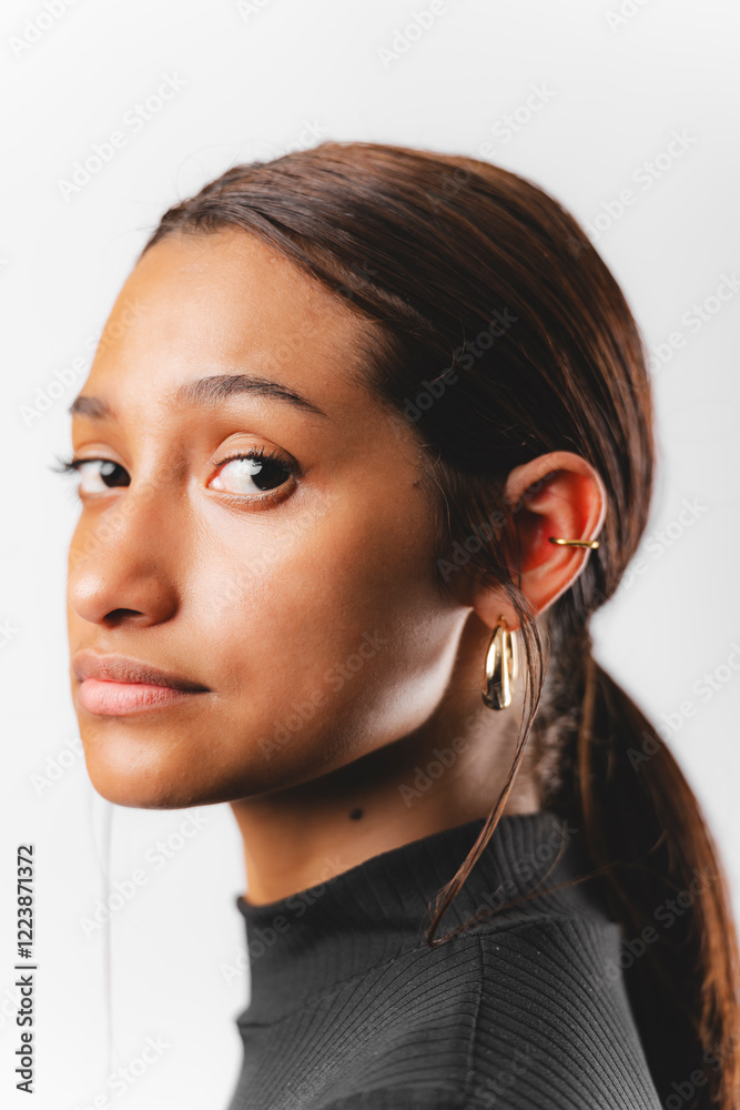 Face photo of cute girl with earrings in her ear Face photo of cute girl with earrings in her ear