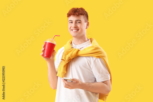 Young redhead man with cup ...