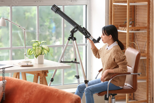 Young Asian woman using tel...