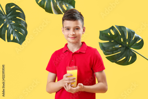 Little boy with glass of or...