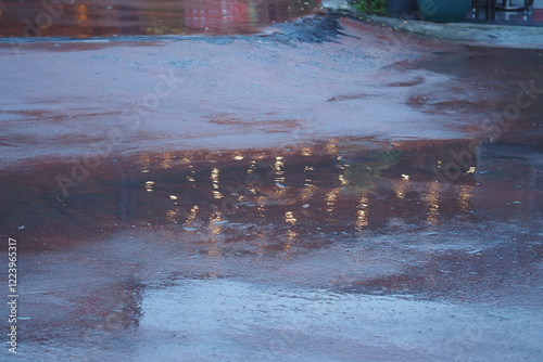 Reflections of lights on a rainy street at dusk photo