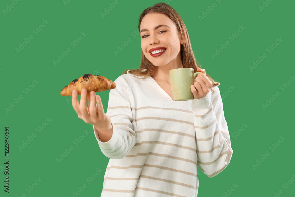 Young woman with cup of tea and tasty croissant on green background Young woman with cup of tea and tasty croissant on green background
