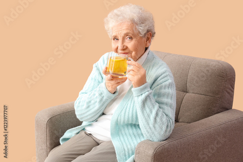 Mature woman drinking lemon...