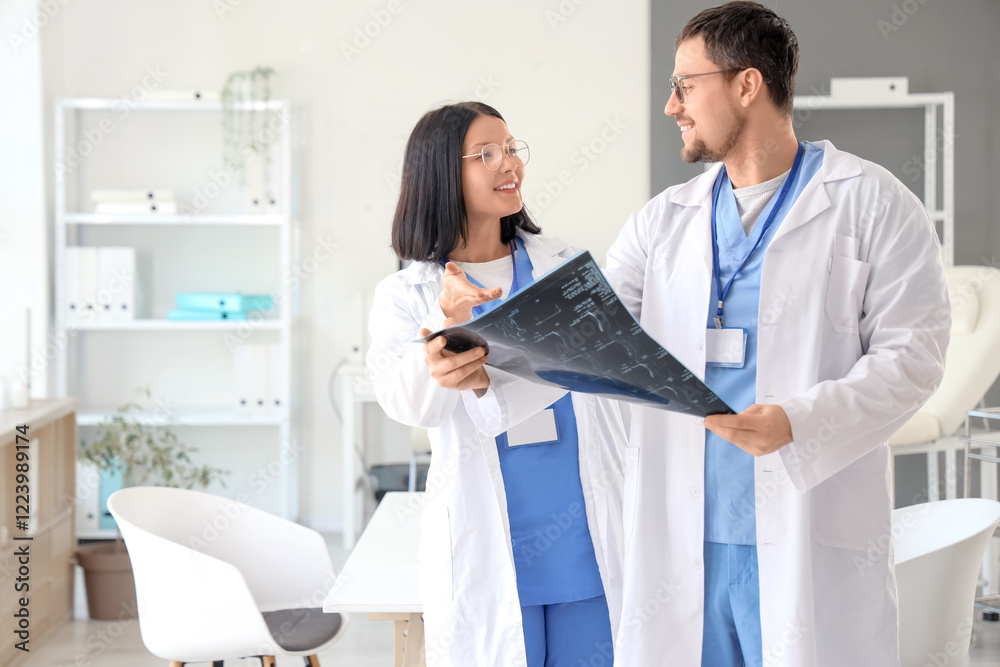 Fototapeta premium Doctors studying x-ray image of spine in clinic