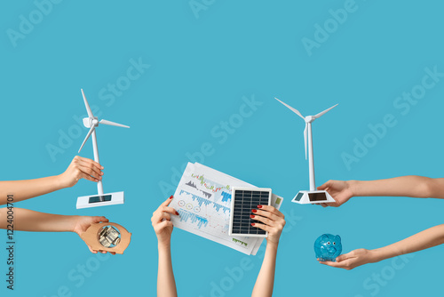 Many hands with wind turbin...