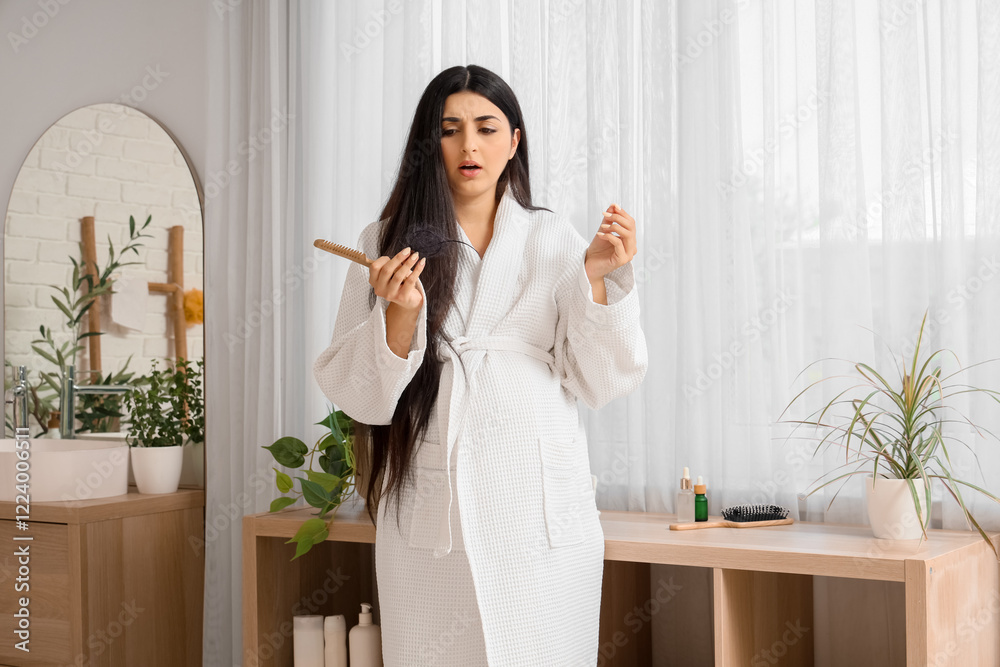 Young pregnant woman with hair loss problem and comb in bathroom Young pregnant woman with hair loss problem and comb in bathroom