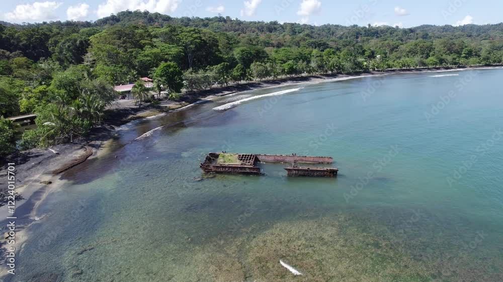 A serene beach with lush forest, a rusted shipwreck, and clear blue waters in Puerto Viejo A serene beach with lush forest, a rusted shipwreck, and clear blue waters in Puerto Viejo