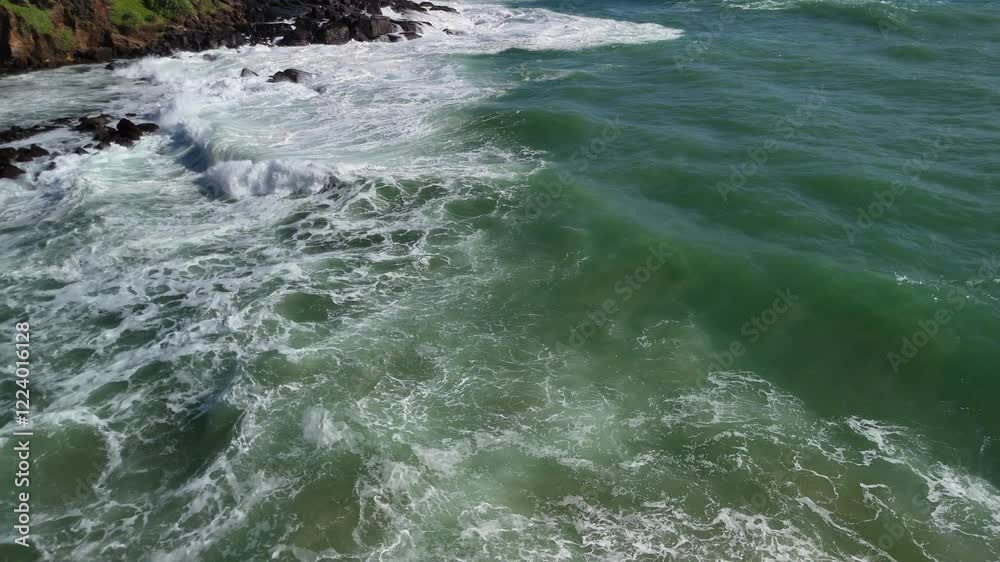 Emerald color ocean water Sri Lanka Parrot rock island coastline aerial drone