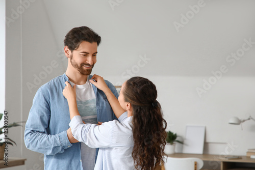Wife adjusting her husband'...