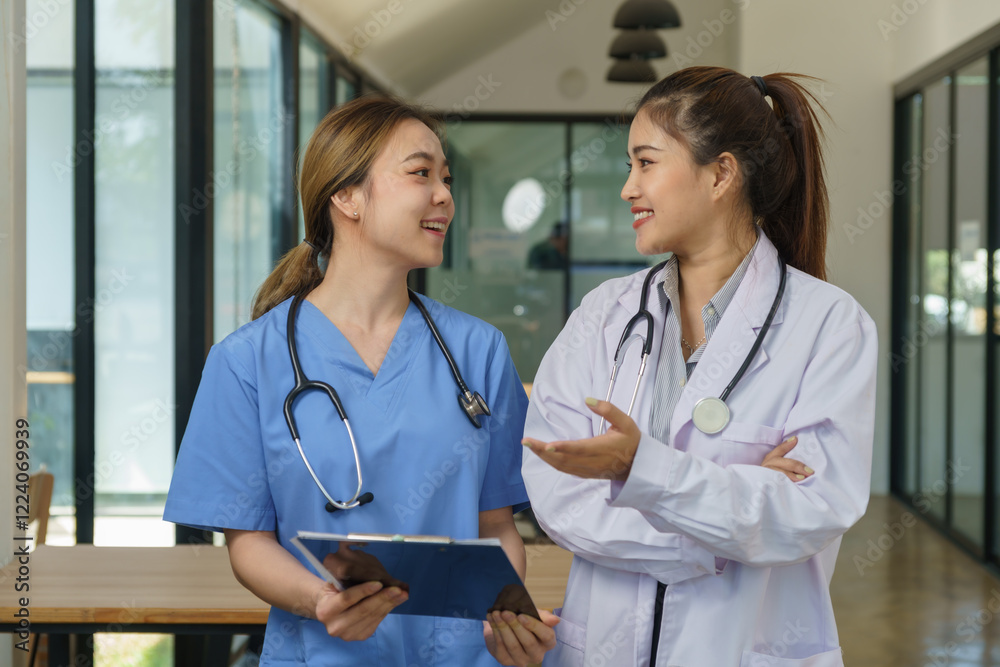 Female healthcare professionals meet to discuss patient records. Female healthcare professionals meet to discuss patient records.