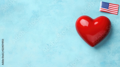 A vibrant red heart on a textured blue background, accompanied by a small American flag, symbolizing love and patriotism.