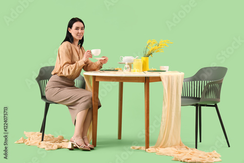 Young woman with cup of tea...