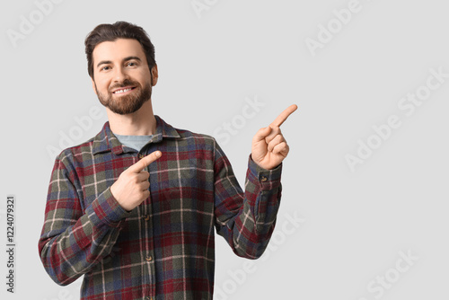 Young man pointing at somet...