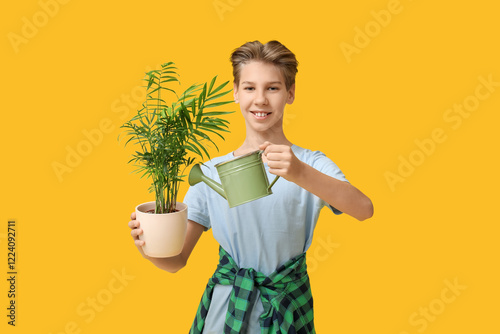 Teenage boy with plant and ...