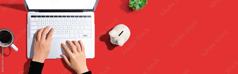 Laptop computer with piggy bank - flat lay Laptop computer with piggy bank - flat lay