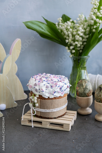 Homemade traditional Easter cake pastry bakery. Festive spring table setting decoration with fresh flowers eggs. Easter family dinner or breakfast idea concept  photo