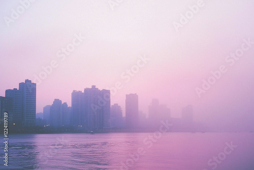 Serene city skyline at dawn with misty reflections on water, evoking tranquility and beauty