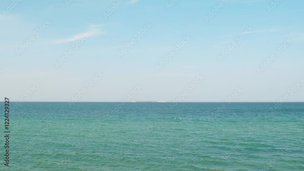 View of calm sea with artificial concrete structure. Empty sea on summer day. Ocean view background. View of calm sea with artificial concrete structure. Empty sea on summer day. Ocean view background.