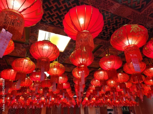 Red Lanterns Hanging: Hundreds of vibrant red lanterns hang from the ceiling, creating a breathtaking and festive atmosphere. The warm glow of the lanterns illuminates the scene.