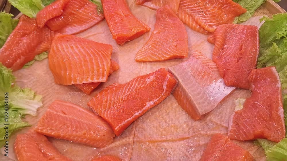 Fresh raw salmon fillets, maintained at a cold temperature for peak freshness, are arranged at the supermarket display. Fresh raw salmon fillets, maintained at a cold temperature for peak freshness, are arranged at the supermarket display.