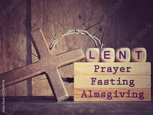 'Lent prayer fasting almsgiving' text on wooden blocks in purple vintage background. Stock photo.