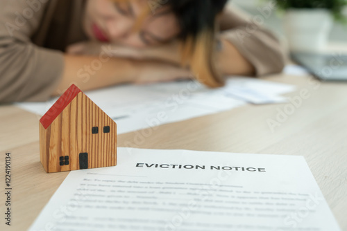 woman is stressed due to imminent seizure of assets, debts, financial problems, loans, guarantees document with the text eviction notice, debt, property, loan, agent, bankruptcy.