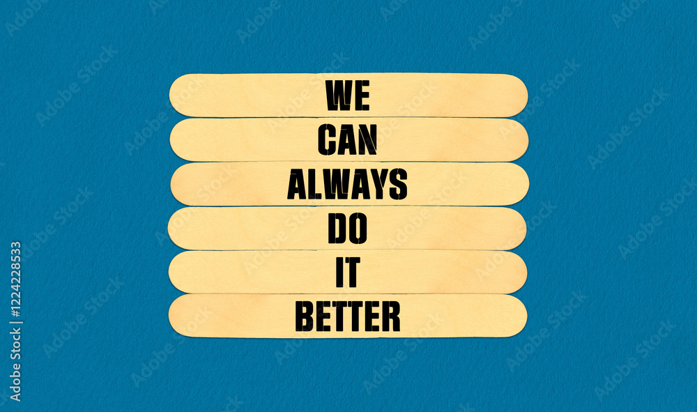 Fototapeta premium We Make it Better Symbol. Concept word We Can Always Do It Better on beautiful wooden stick. Beautiful Blue Chart Paper Background. Business and We Make it Better concept. Copy space