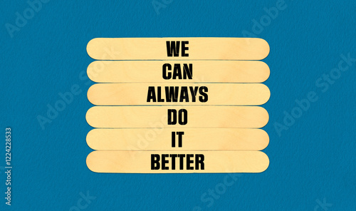 We Make it Better Symbol. Concept word We Can Always Do It Better on beautiful wooden stick. Beautiful Blue Chart Paper Background. Business and We Make it Better concept. Copy space