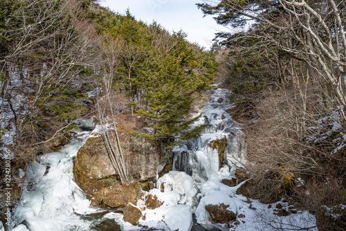 Waterfalls, the Ryūzu Falls located upstream from the Yugawa River which makes its way into Lake Yunoko and Lake Chūzenji located near Nikko at daytime in winter with snow in Japan. photo