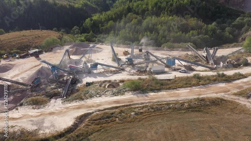 Aerial view of stone quarry conveyor belt system in operation, stone jaw crusher plant