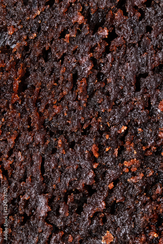 Macro texture of brownie pie. Sticky and moist chocolate sponge cake close up. Fudge cake