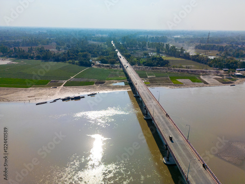 Aerial View of a Modern Road Bridge Over a Reflective River in Rangpur, Bangladesh photo