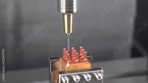 The CNC milling machine cutting the copper electrode parts with ball nose end mill tool.