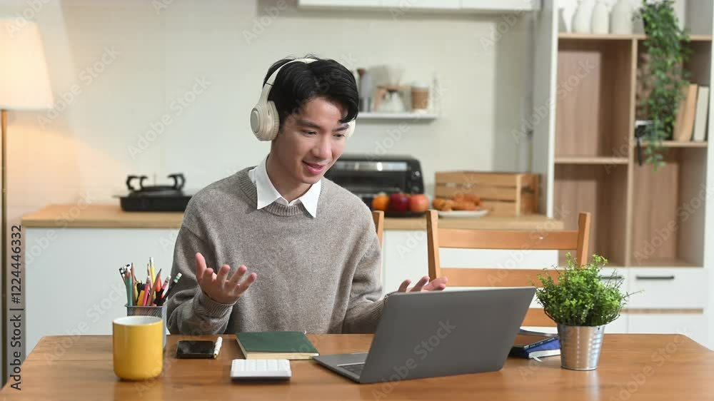 Attractive happy young Asian student studying at the college library, sitting at the desk Attractive happy young Asian student studying at the college library, sitting at the desk