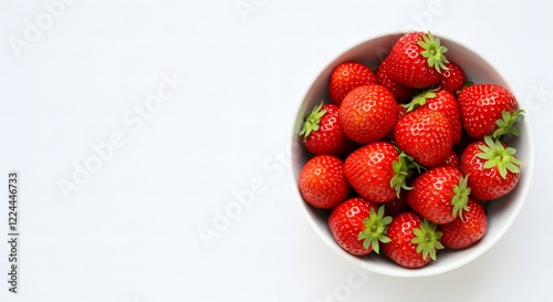White ceramic bowl filled with fresh ripe strawberries on a clean white background perfect for healthy eating, desserts, or natural food designs