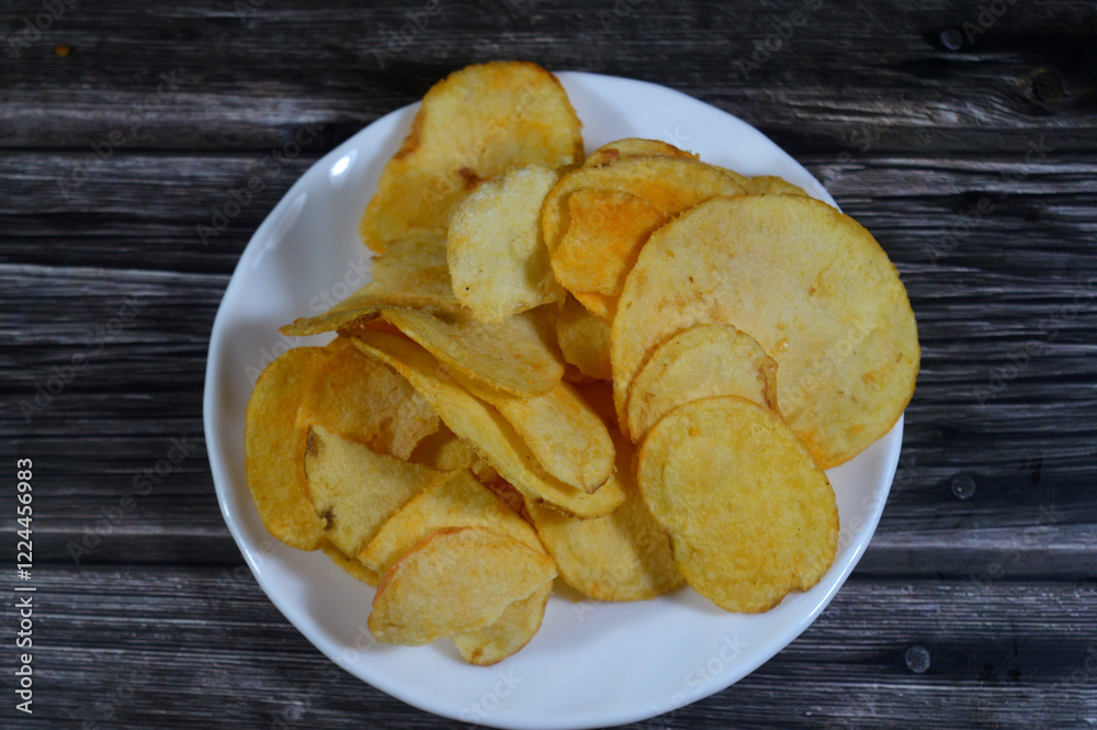 Potato chips, crisps, thin slices of potato, deep fried, baked, or air fried until crunchy, served as a snack, side dish, or appetizer, basic chips are cooked and salted, some with other flavors Potato chips, crisps, thin slices of potato, deep fried, baked, or air fried until crunchy, served as a snack, side dish, or appetizer, basic chips are cooked and salted, some with other flavors