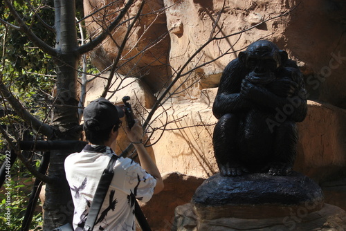 person use dji camera at monkey statue