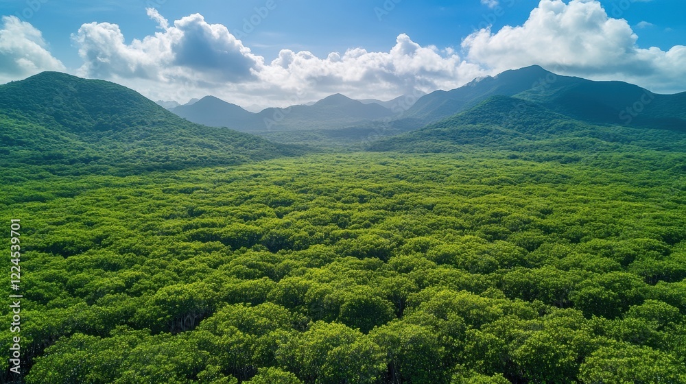 Fototapeta premium Verdant mountain landscape with lush forests under a blue sky and clouds