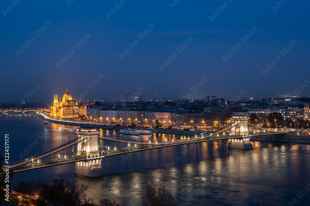Fototapeta premium View of Danube River, the Szechenyi Chain Bridge and Parliament of Hungary illuminated at night