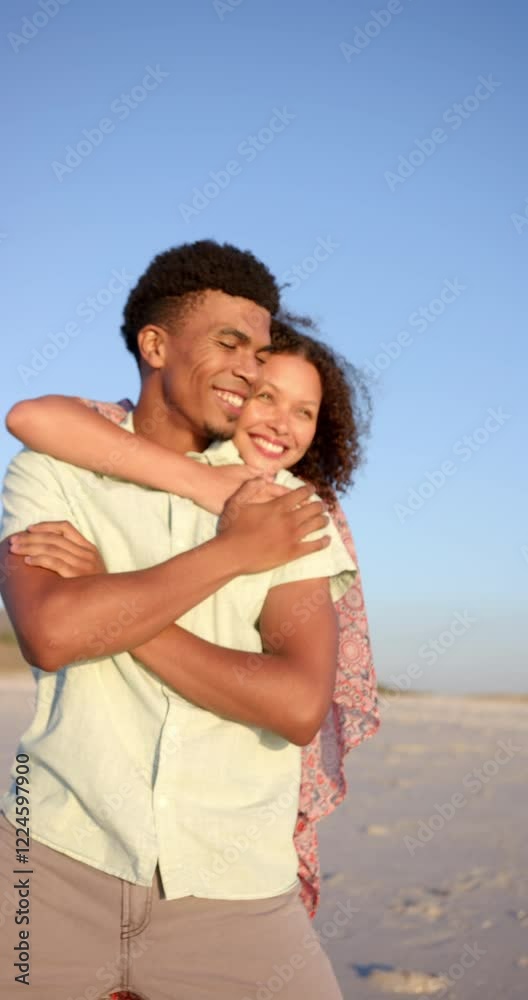 Vertical video: Embracing on beach, couple smiling and enjoying sunset together Vertical video: Embracing on beach, couple smiling and enjoying sunset together