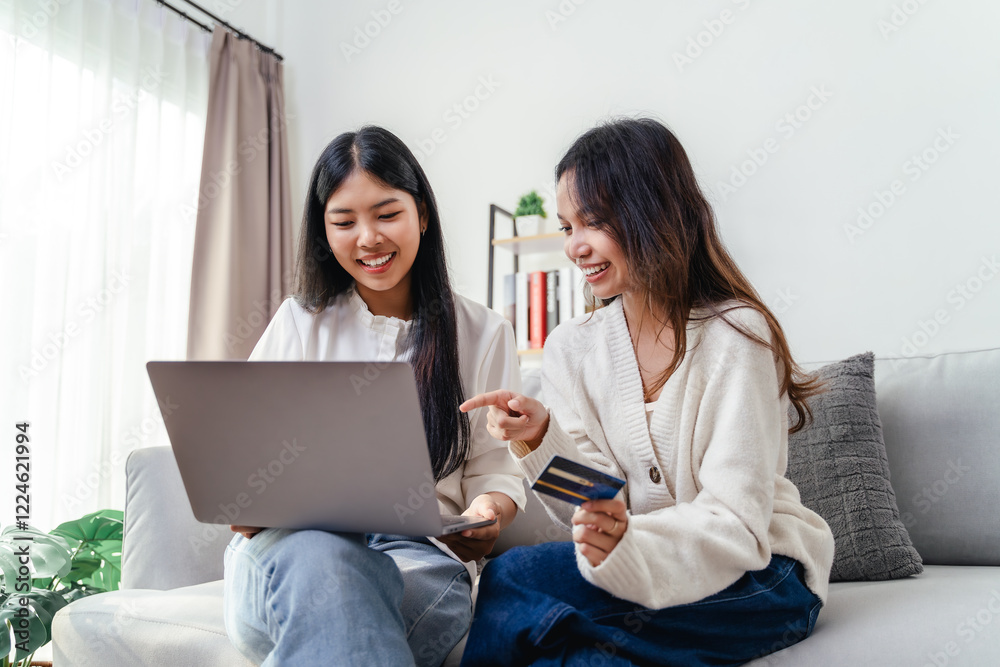 Two women are using laptops and credit cards to pay for purchases and shopping online Two women are using laptops and credit cards to pay for purchases and shopping online