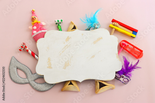 Purim celebration concept (jewish carnival holiday) over pink background photo