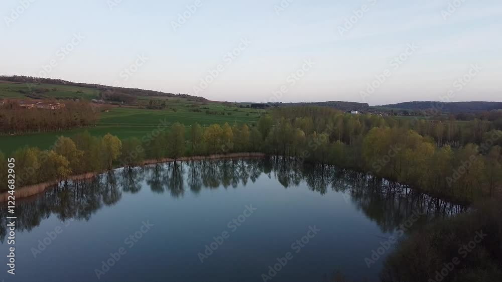 Beautiful Aerial View of a Lake Surrounded by Countryside Fields Beautiful Aerial View of a Lake Surrounded by Countryside Fields