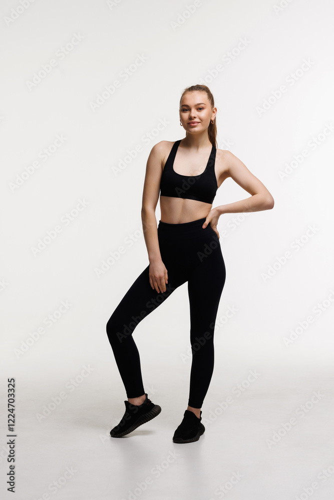 Smiling fit woman in fitness outfit isolated on white background with copy space. Smiling fit woman in fitness outfit isolated on white background with copy space.